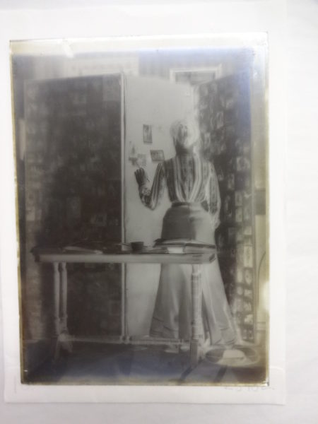 View of a lady pasting photographs