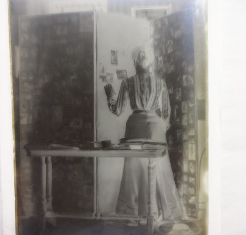 View of a lady pasting photographs