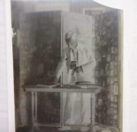 Dr Baker looking through photograph albums