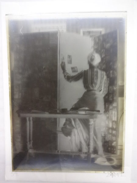 Unidentified lady assembling photographs on a screen
