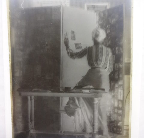 Unidentified lady assembling photographs on a screen