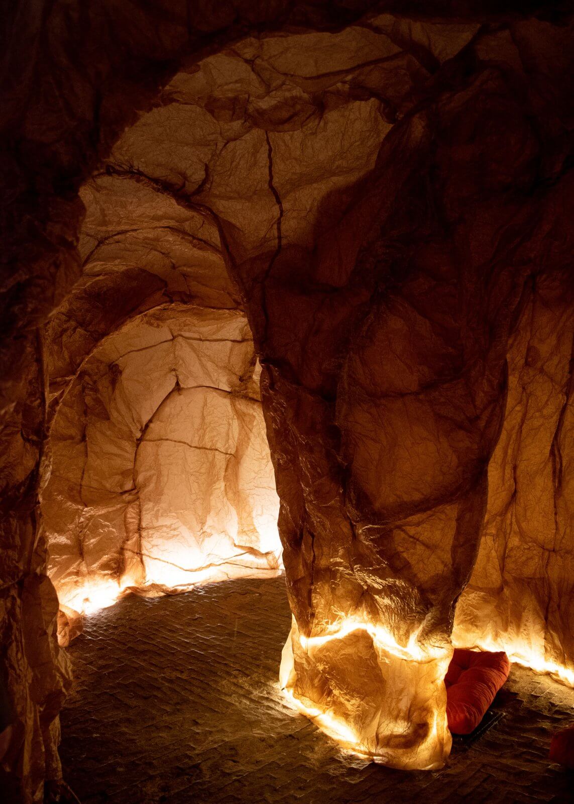 Detail of the Templum, showing the brown paper walls over a wire frame and lighting on the floor.