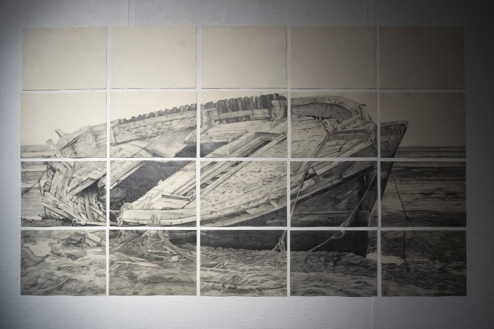 a detailed drawing of a broken wooden boat. The drawing is broken up into a grid of 20 A4 sheets